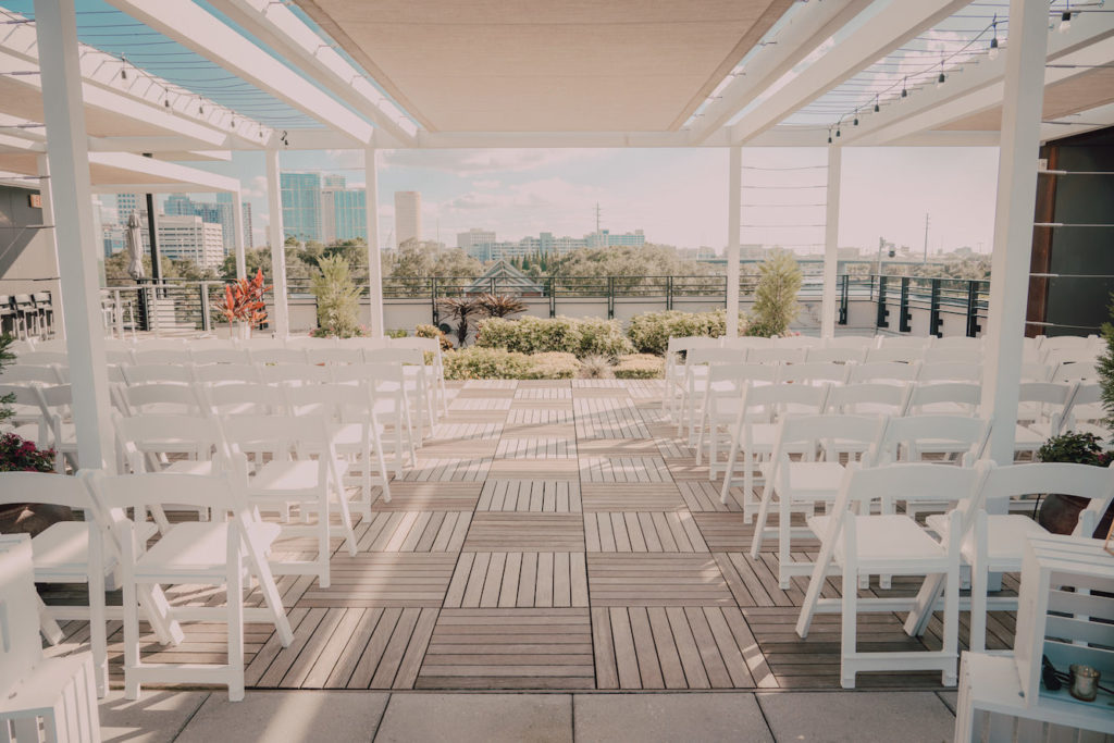 Tampa Heights Rooftop Wedding Ceremony at Rooftop 220 with white Garden Chairs | UNIQUE Weddings + Events