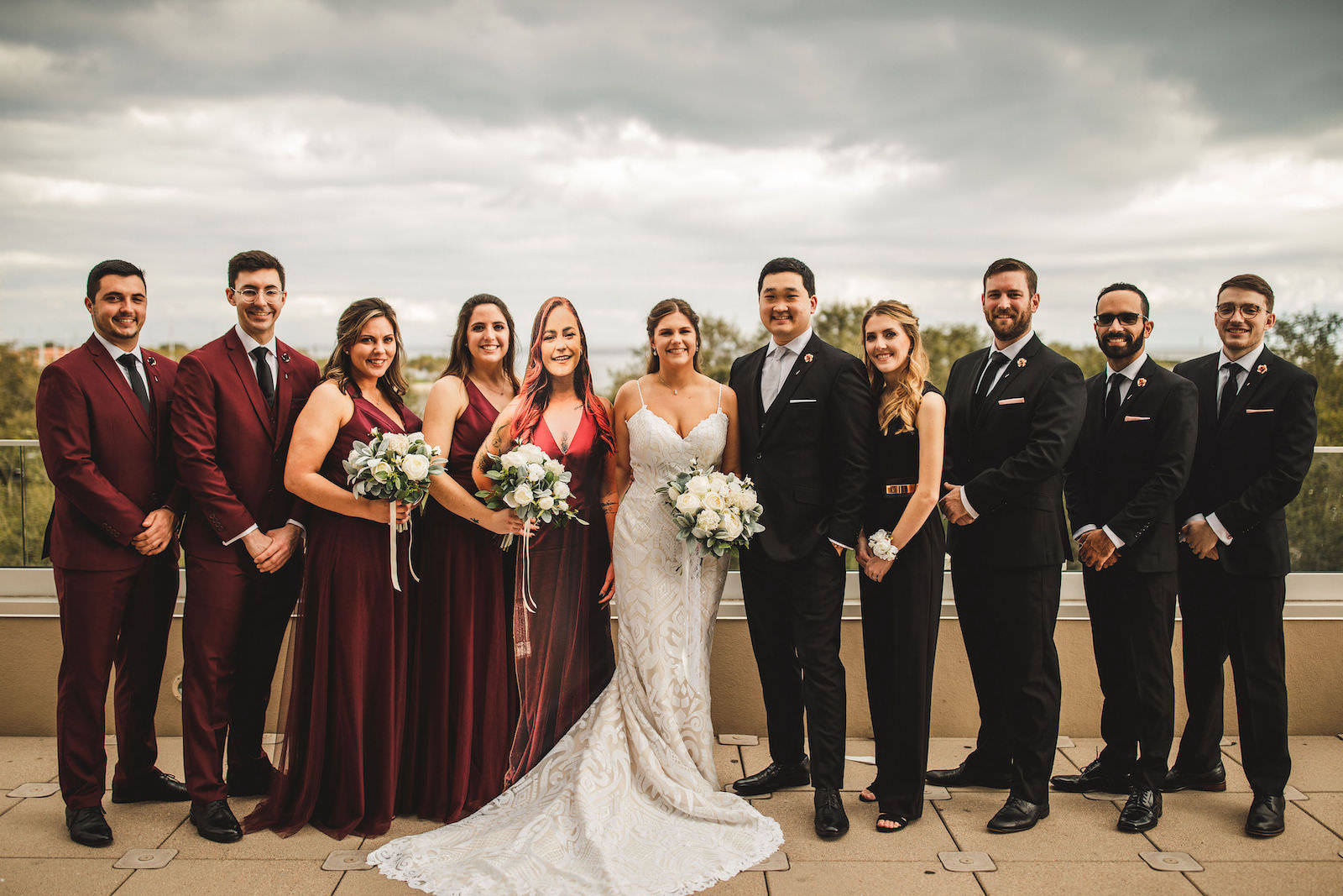 Bride in Lace Spaghetti Strap Fit and Flare Casablanca Bridal Wedding Dress, Bridesmaids in Burgundy Red Dresses, Groomsmen in Black Suits