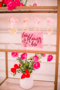 Champagne Wall Display with Pink and Red Rose Decor and Valentine Decor on Gold Shelving