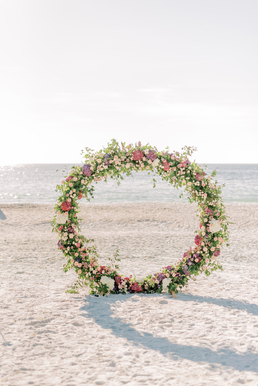 Florida Beach Wedding Ceremony Decor, Round Arch with Greenery, Ivory and Pink Florals | Tampa Bay Wedding Photographer Kera Photography | Waterfront Wedding Venue Ritz Carlton Sarasota