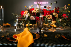 Urban and Edgy Wedding Reception Decor, Black Wall, Water Goblets, Table Linens, Gold Charger, Yellow Mustard Linen Napkin, Red and Yellow Roses with Greenery Floral Centerpiece | Tampa Bay Wedding Photographer Bonnie Newman Creative | Wedding Designer and Planner UNIQUE Weddings + Events | Wedding Venue Aloft/ Element Midtown Tampa | Wedding Floral and Decor Monarch Events and Design | Wedding Lighting Spark Wedding Events | Wedding Rentals A Chair Affair | Wedding Linens Over the Top Rental Linens