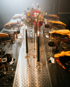 Urban and Edgy Wedding Reception Decor, Black Wall, Water Goblets, Unique Textured Table Linens and Silver Textured Table Runner, Black Candlesticks, Gold Chargers, Yellow Mustard Linen Napkin, Red and Yellow Roses with Greenery Floral Centerpiece | Tampa Bay Wedding Photographer Bonnie Newman Creative | Wedding Designer and Planner UNIQUE Weddings + Events | Wedding Venue Aloft/ Element Midtown Tampa | Wedding Floral and Decor Monarch Events and Design | Wedding Lighting Spark Wedding Events | Wedding Rentals A Chair Affair | Wedding Linens Over the Top Rental Linens