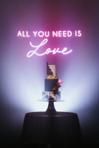 Urban and Edgy Wedding Decor, Pink Neon Sign "All You Need is Love", Four Tier Marble Black and Gold Wedding Cake | Tampa Bay Wedding Photographer Bonnie Newman Creative | Wedding Cake The Artistic Whisk | Wedding Design and Planner UNIQUE Weddings + Events | Wedding Lighting Spark Weddings and Events