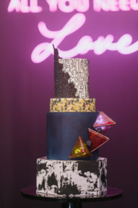 Unique Edgy and Urban Black, White, and Gold Round and Geometric Wedding Cake with Art Deco Inspo Design, Red 3D Geometric Triangles | Tampa Wedding Photographer Bonnie Newman Creative | Wedding Cake The Artistic Whisk | Wedding Designer and Planner UNIQUE Weddings + Events | Wedding Lighting Spark Weddings and Events