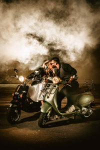 Urban and Edgy Bride in Leather Jacket on Silver Moto Scooter, Groom in Black Dress Shirt and Pants with Gray Vest on Black Scooter and Smoke | Tampa Bay Wedding Photographer Bonnie Newman Creative | Wedding Designer and Planner UNIQUE Weddings + Events