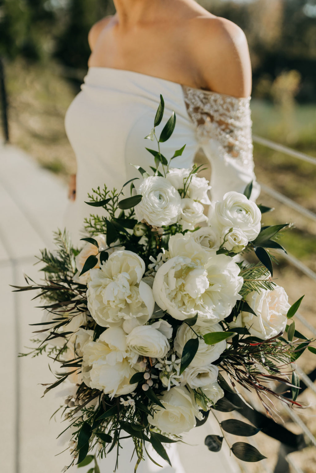 Florida Winter Wedding Bouquet with White Peony Garden Roses, Ranunculus, and Pine Greenery | Off the Shoulder Lace Sleeve Wedding Gown Bridal Dress | Amber McWhorter Photography