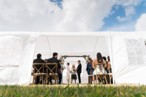 Bride and Groom Exchanging Wedding Vows Under White Tent During Rustic Wedding Ceremony | Tampa Bay Wedding Planner Eventfull Weddings