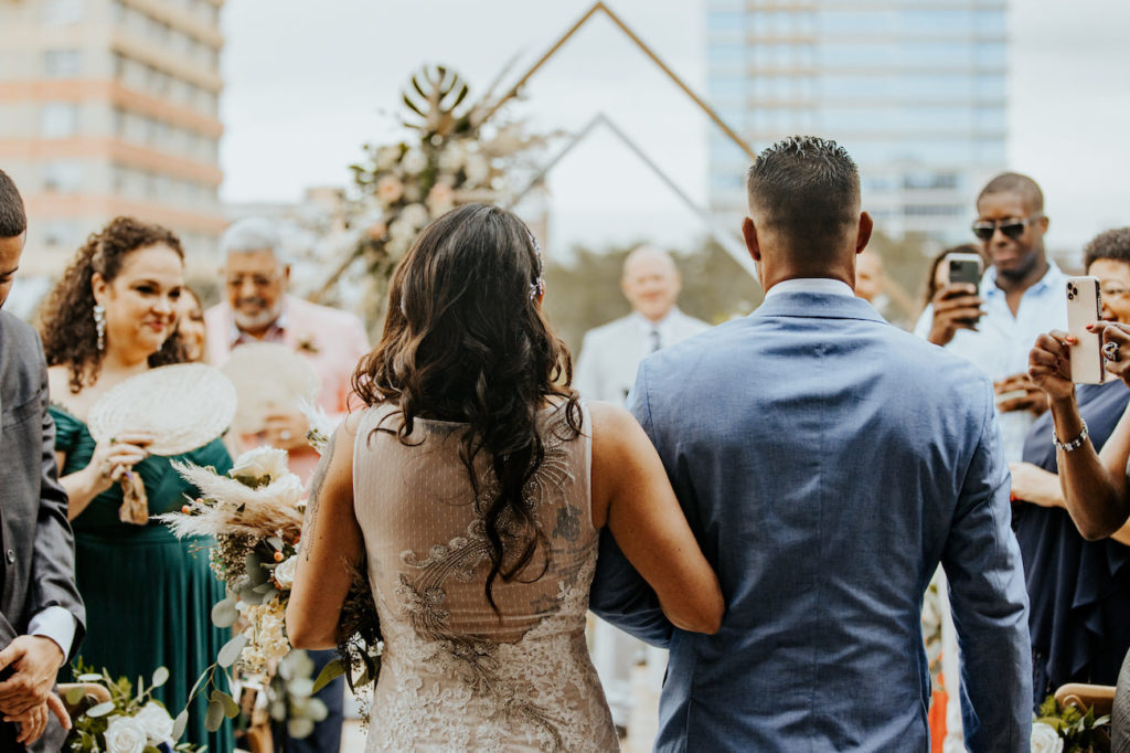 Bride and Father Walking Down the Aisle during Boho St. Pete Florida Wedding at Red Mesa Events Rooftop