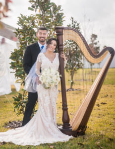 Tampa Bride in Romantic Lace and Illusion Long Sleeve Wedding Dress with Nude Lining and Groom Posing with Harp | Tampa Bay Wedding Planner Eventfull Weddings | Wedding Hair and Makeup Femme Akoi Beauty Studio
