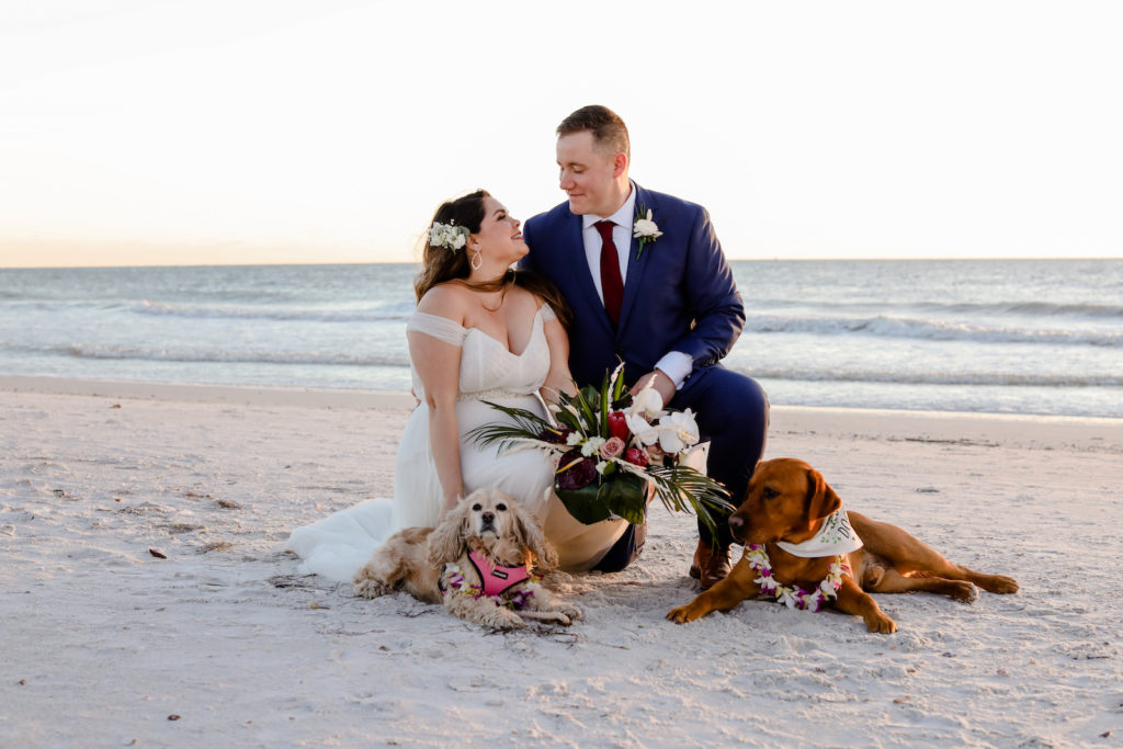 Florida Sunset Portrait of Bride and Groom on Beach with Dogs | Tampa Bay Wedding Photographer Lifelong Photography Studio | St. Pete Beach Wedding Venue Postcard Inn | Wedding Florist Iza's Flowers