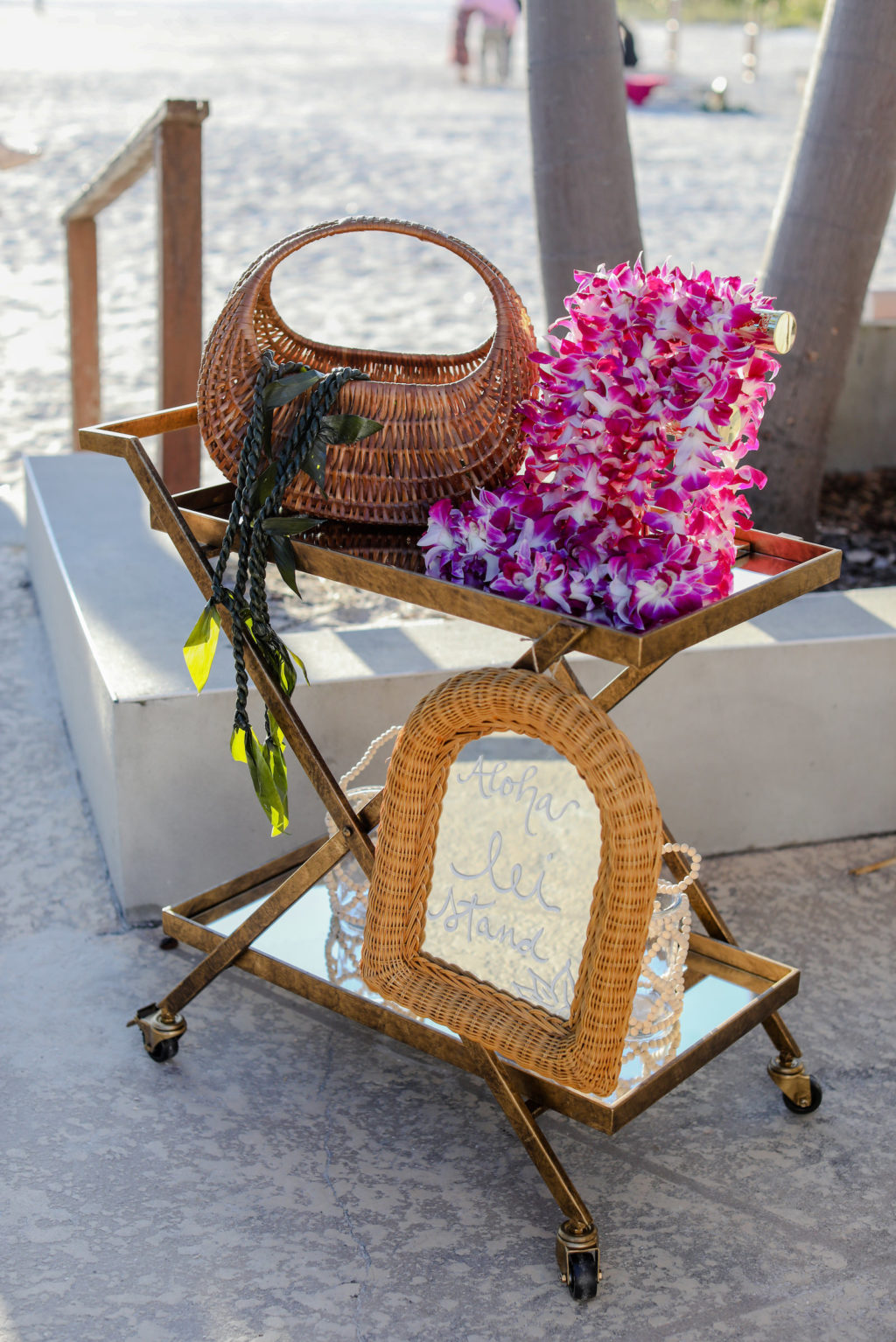 Tropical Wedding Reception Decor, Vintage Bar Cart with Purple Orchid Flower Leis, Woven Basket and Mirror | Tampa Bay Wedding Photographer Lifelong Photography Studio