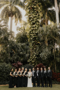 Classic Florida Wedding Party at Sunken Gardens in Downtown St. Petersburg, Brides Wearing Mix and Match Long Black BHLDN Bridesmaid Dresses, Groomsmen in Classic Black Suit and Tie | Tampa Bay Wedding Hair and Makeup Artist Femme Akoi Beauty Studios