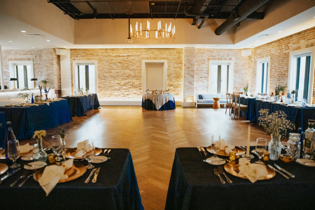 Boho Wedding Reception at Downtown St. Pete Venue Red Mesa Events | Navy Blue Reception Tables with Copper Gold Charger Plates