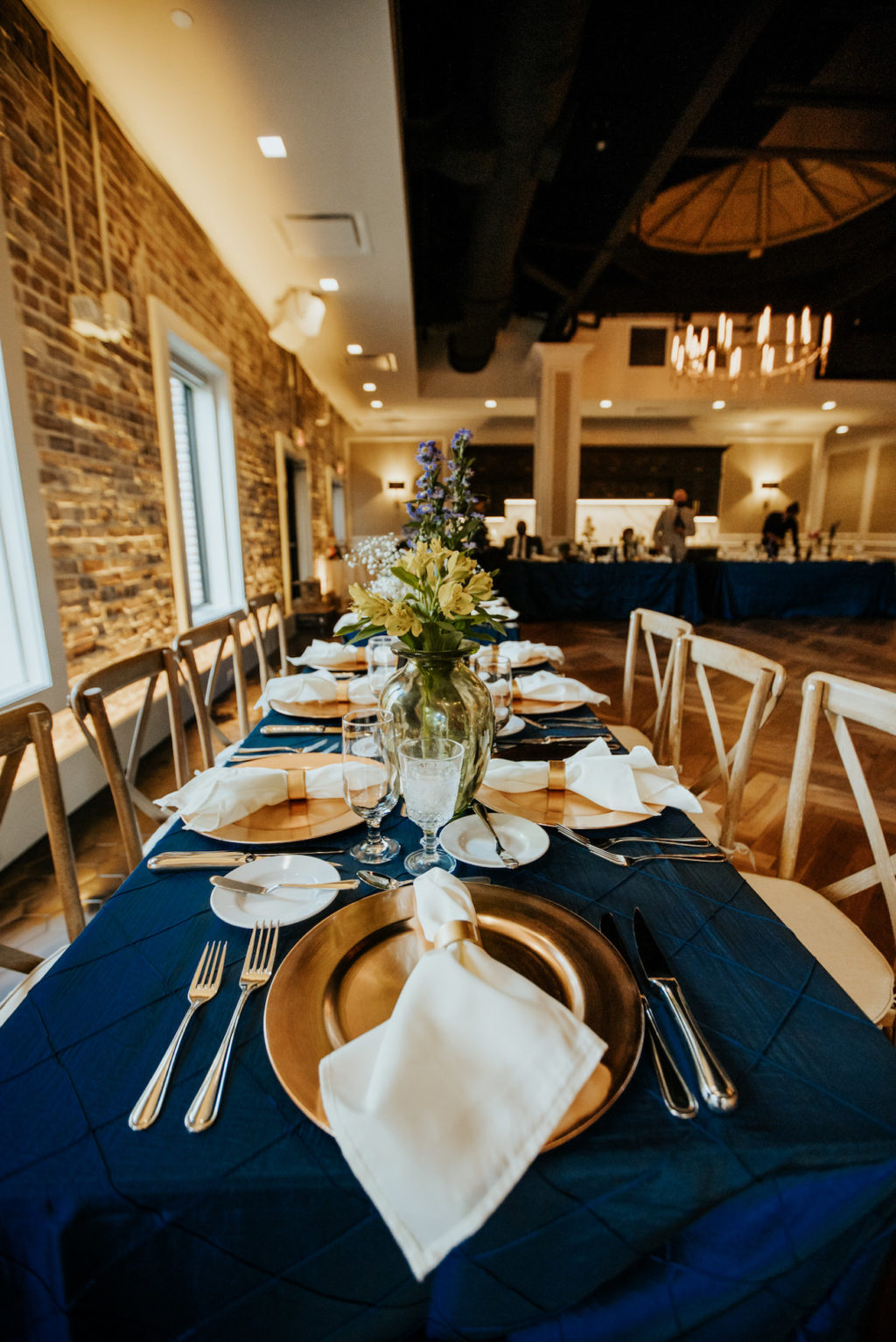 Boho Wedding Reception at Downtown St. Pete Venue Red Mesa Events | Navy Blue Reception Tables with Copper Gold Charger Plates and White Napkins