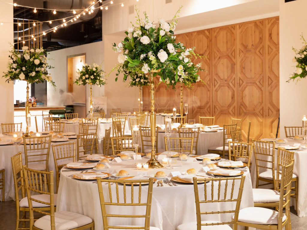 Traditional Classic Wedding Reception Decor, Round Tables with Gold Chiavari Chairs, Tall Gold Greenery and White Floral Centerpieces, Hanging String Lights | Tampa Bay Wedding Venue Hyde House