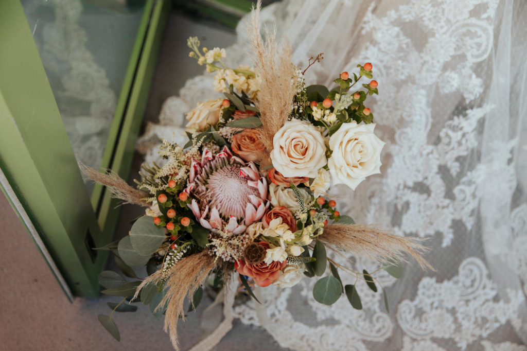 Boho Wedding Bridal Bouquet with White and Copper Roses, Hypericum Berry, Pampas Grass, Astilbe, and Pink Protea