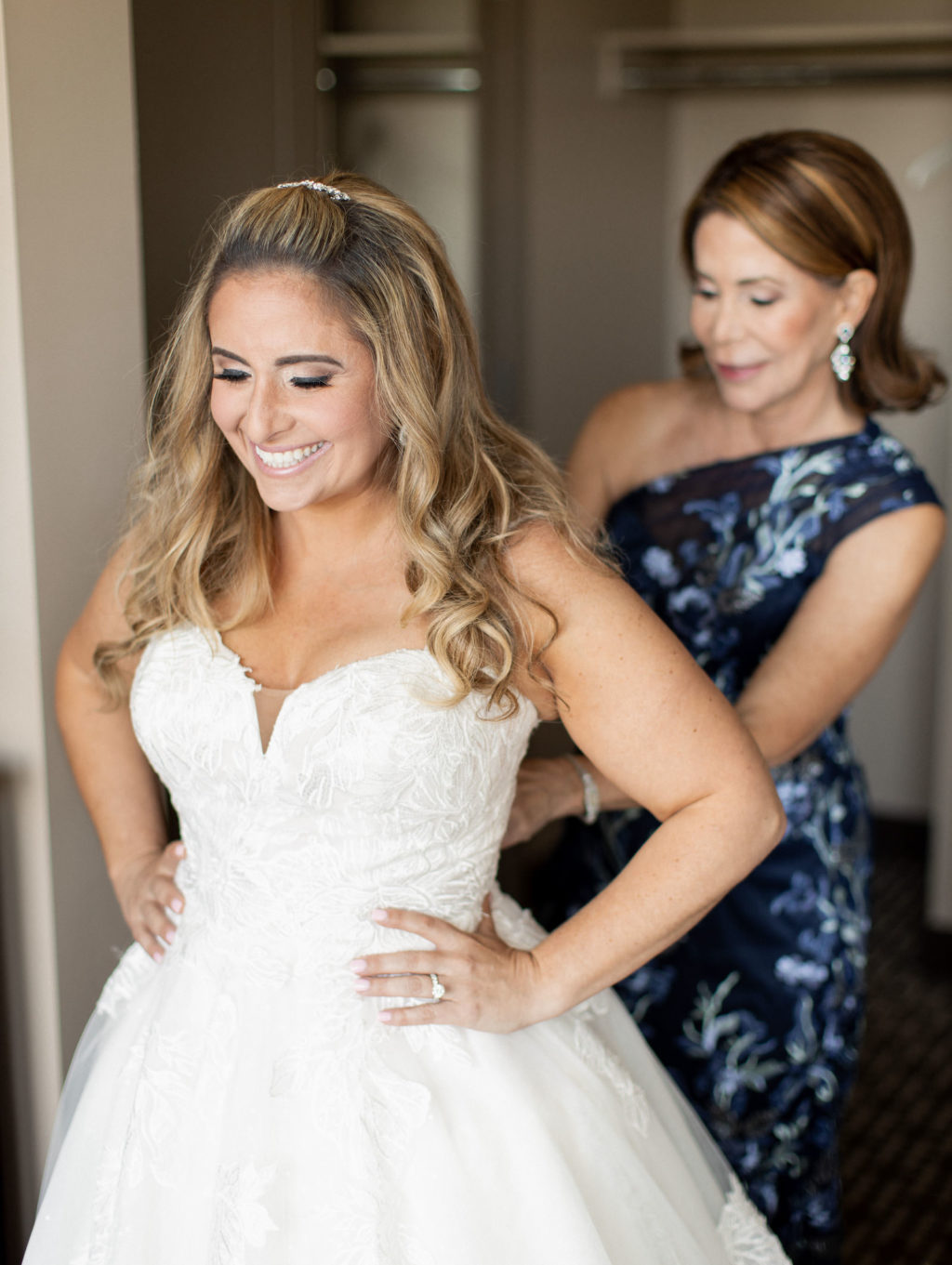 Tampa Bay Bride Getting Ready Putting on Ballgown Tulle and Lace Wedding Dress