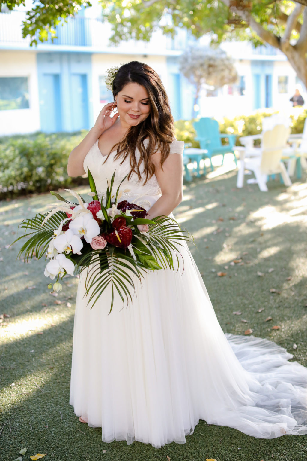 Tampa Bride Wearing Tull and Chantilly Lace Off the Shoulder Dreamy Boho Wedding Dress Holding Tropical White Orchid, Burgundy Anthuriums and Palm Fronds Floral Bouquet | St. Pete Beach Wedding Venue Postcard Inn | Tampa Bay Wedding Photographer Lifelong Photography Studio | Wedding Florist Iza's Flowers