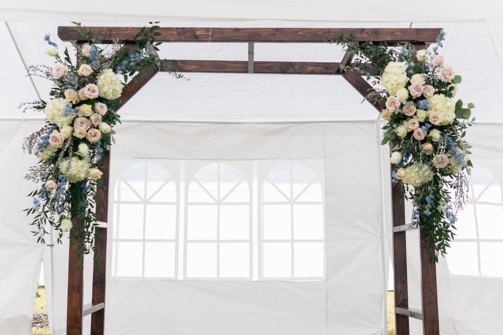 Rustic Wedding Ceremony Decor, Wooden Arch with Lush Floral Arrangements, White Hydrangeas, Blush Pink Roses, Blue and Purple Flowers, Greenery | Tampa Bay Wedding Planner Eventfull Weddings