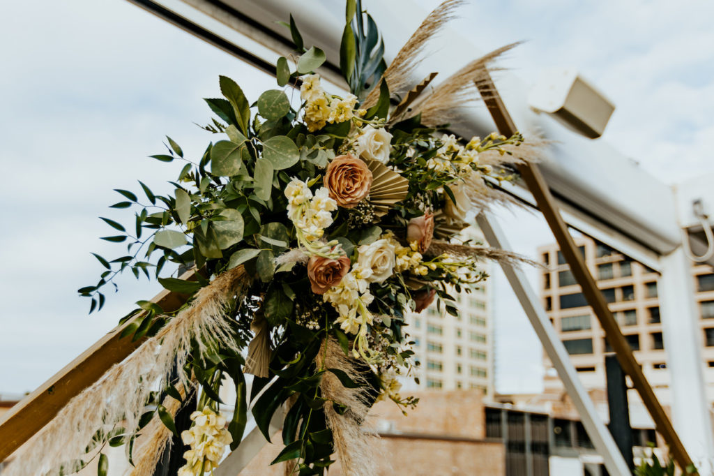 Boho St. Pete Florida Wedding Ceremony Arch Floral Spray Arrangement with White and Copper Quicksand Roses, White Stock, Pampas Grass, and Tropical eucalyptus Greenery