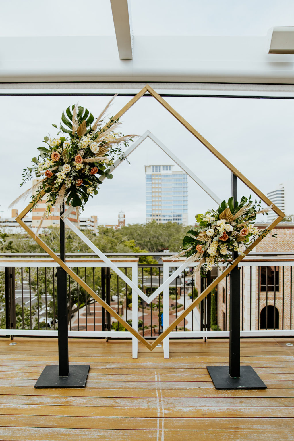 Boho St. Pete Florida Wedding at Red Mesa Events Rooftop | Geometric Diamond Ceremony Arch Floral Spray Arrangement with White and Copper Quicksand Roses, White Stock, Pampas Grass, and Tropical eucalyptus Greenery