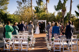 Florida Bride and Groom Exchanging Wedding Vows During Outdoor Courtyard Ceremony | St. Pete Wedding Venue Hotel Zamora