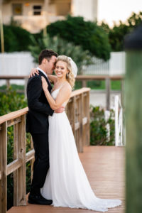 Florida Bride and Groom Intimate Photos on Dock Holding White and Mauve Roses Round Floral Bouquet | Tampa Bay Wedding Dress Isabel O'Neil Bridal | Wedding Florist Iza's Flowers