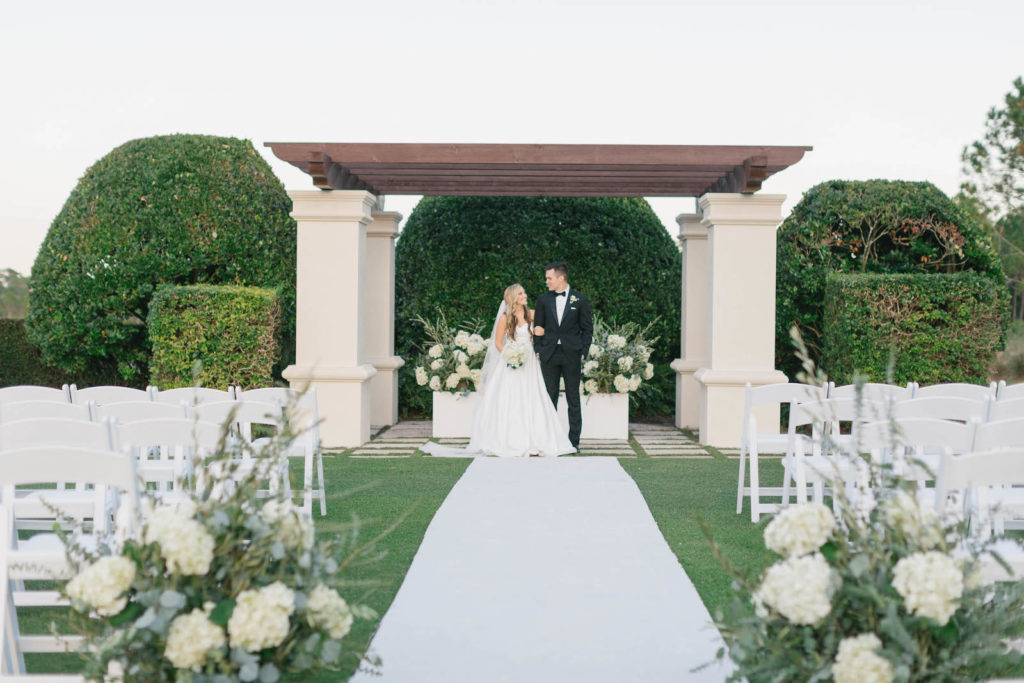 Classic Bride and Groom Under Pergola, Lush White Hydrangeas Eucalyptus and Greenery Floral Arrangements | Tampa Bay Wedding Planner Parties A'la Carte | Bradenton Wedding Venue Concession Golf Club | Wedding Rentals Kate Ryan Event Rentals