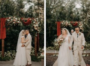 Rustic Bride in Flowy Lace Bodice and Tulle Skirt A-Line Wedding Dress and Groom in Tan Suit, Wooden Arch with Lush Floral Arrangements and Burnt Orange Draping | Plant City Florida Rustic Barn Weddings | Tampa Bay Wedding Hair and Makeup Femme Akoi Beauty Studio