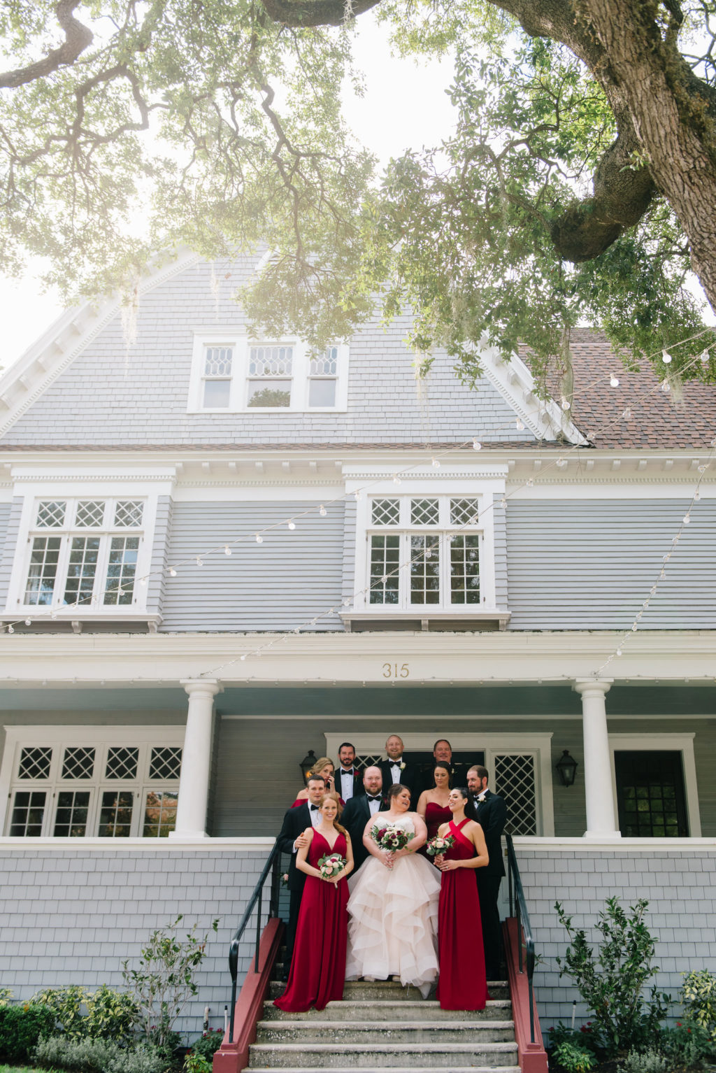 Florida Bride and Wedding Party on Stairs Outside Tampa Bay Wedding Venue The Orlo