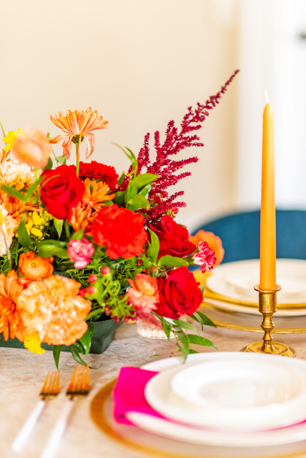 Tampa Wedding Styled Shoot 70's Retro Vintage | Colorful Vibrant Rainbow Wedding Centerpiece with Daisies, Roses, Ranunculus, Stock and Astilbe | Gold Rim Charger and China with Dipped Gold Flatware and Colorful Napkin by Kate Ryan Event Rentals