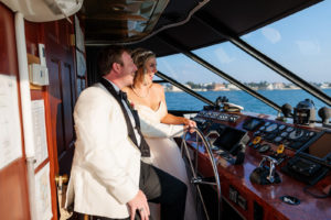 Florida Bride and Groom in White Tuxedo Driving Boat | Waterfront Wedding Venue Yacht Starship | Tampa Bay Wedding Photographer Limelight Photography