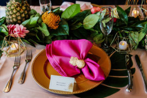 Tropical Wedding Reception Decor, Gold Chargers, Hot Pink Linen Napkin with Gold Pineapple Ring Holder, Geometric Gold Candle Holders, Greenery Leaves and Flower Table Runner Garland, Pineapples | Tampa Bay Wedding Photographer Limelight Photography