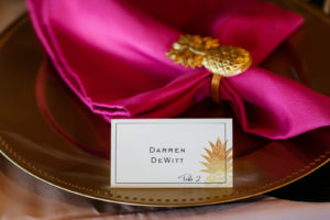 Tropical Wedding Reception Decor, Gold Charger with Hot Pink Linen Napkin and Gold Pineapple Ring Holder, White and Gold Pineapple Foil Stamped Seating Place Card | Tampa Bay Wedding Photographer Limelight Photography
