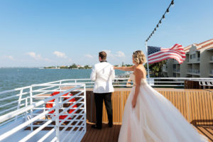 Florida Bride in Ballgown Strapless Wedding Dress with Tulle Skirt and Blush Pink Lining, Floral Belt First Look with Groom in White Tuxedo | Waterfront Wedding Venue Yacht StarShip | Tampa Bay Wedding Photographer Limelight Photography