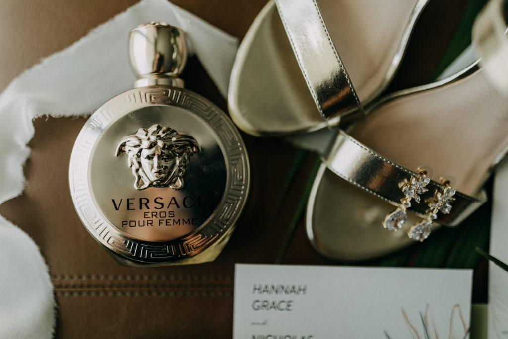 Bridal Elegant Wedding Accessories, Versace Perfume Bottle, Silver Strappy Wedding Shoes, Dangling Rhinestone Gold Earrings | Tampa Bay Wedding Photographer Amber McWhorter Photography