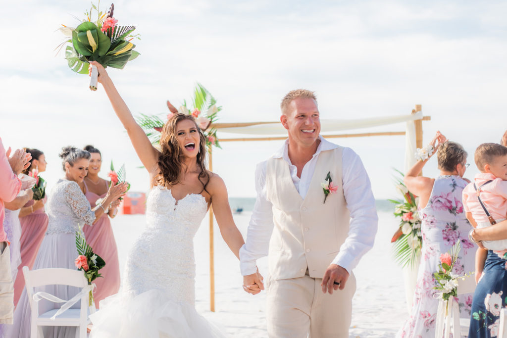 Tropical Bride and Groom Wedding Ceremony Exit | Wedding Venue Hilton Clearwater Beach | Wedding Florist Iza's Flowers