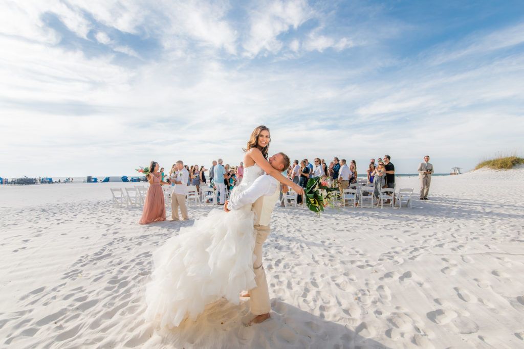 Romantic Tropical Groom Holding Bride Up on Sands of Beach | Wedding Venue Hilton Clearwater Beach