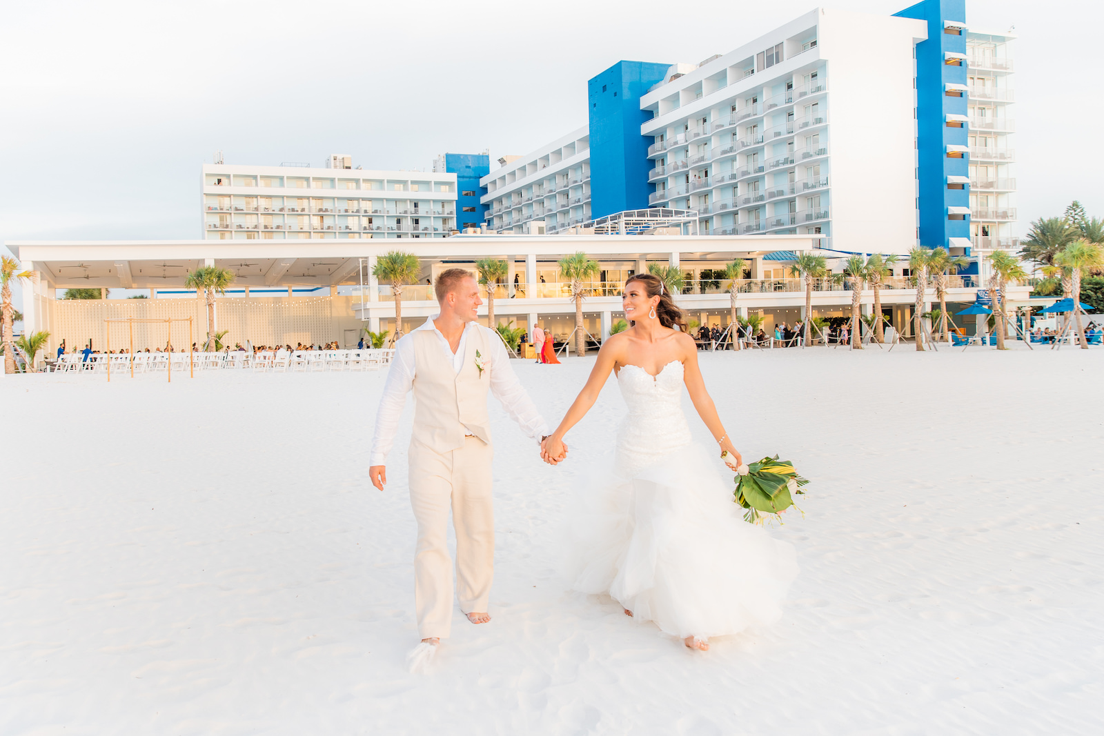 Tropical Bride and Groom Holding Hands Walking on Beach of Wedding Venue Hilton Clearwater Beach
