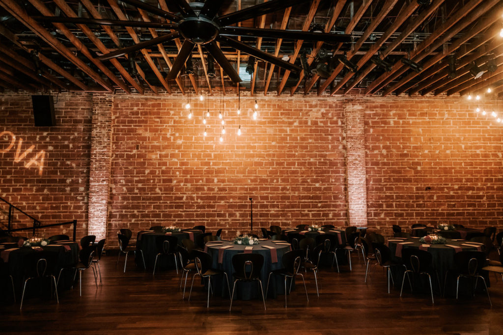 Industrial Florida Wedding Reception, Dark and Moody Decor against Exposed Brick Wedding Venue with Romantic Lighting | Downtown St. Pete Wedding Venue NOVA 535