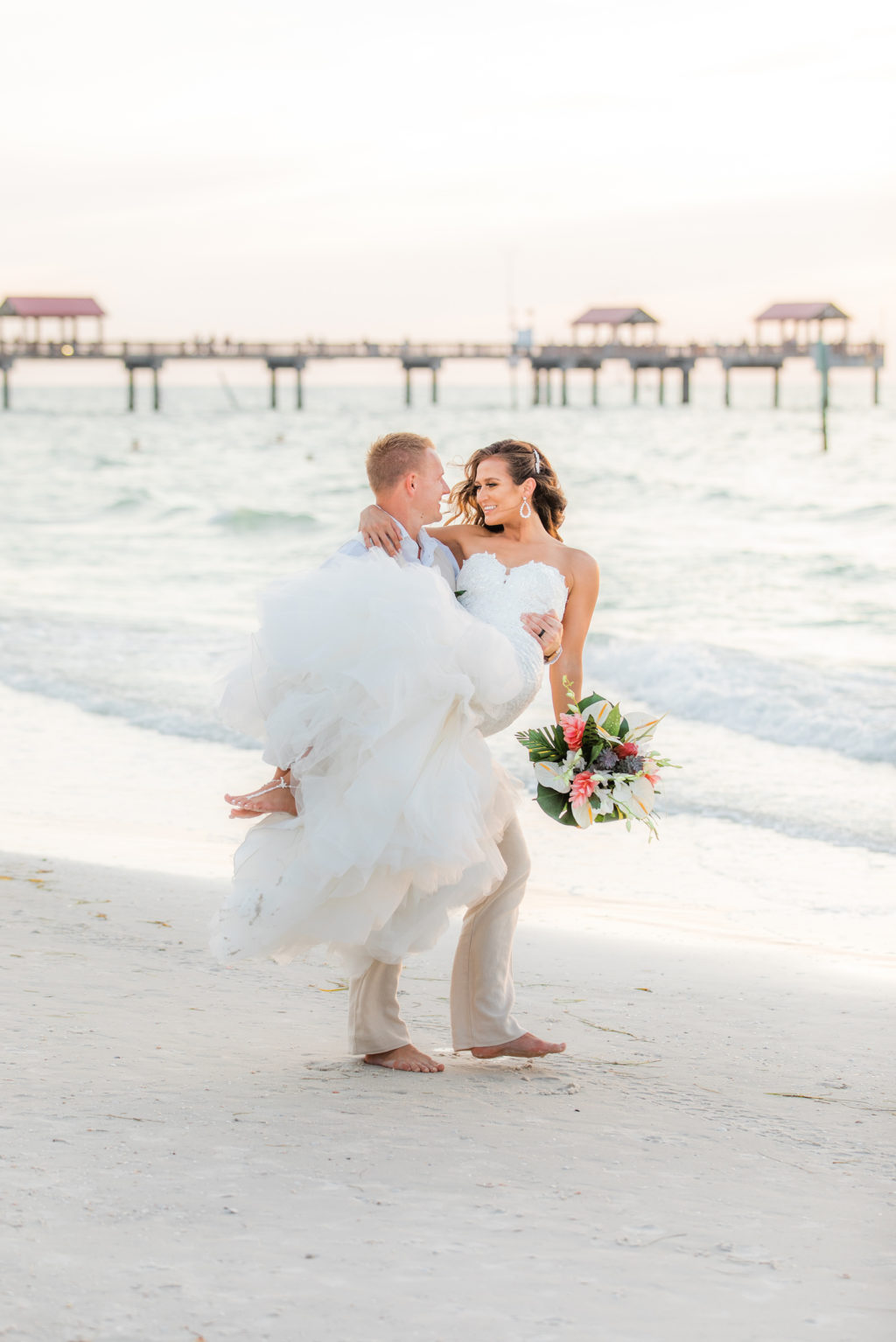 Romantic Groom Carrying Bride on Sandy Beach During Sunset | Wedding Venue Hilton Clearwater Beach