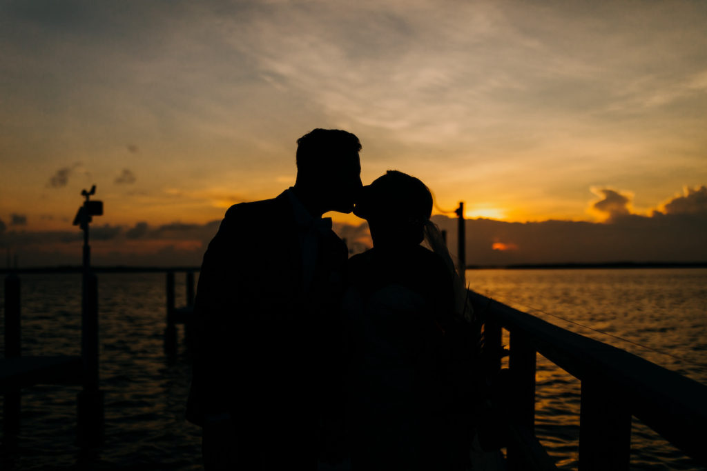 Sunset Silhouette Waterfront Wedding Portrait of Bride and Groom | Tampa Bay Wedding Photographer Amber McWhorter Photography