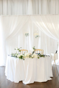 Classic Wedding Reception Decor, Sweetheart Table with White Linen Backdrop, Hydrangeas, Roses and Greenery Floral Bouquets, Gold Chairs | Tampa Bay Wedding Photographer Lifelong Photography Studio | Wedding Planner Core Concepts | Wedding Rentals A Chair Affair | Kate Ryan Event Rentals