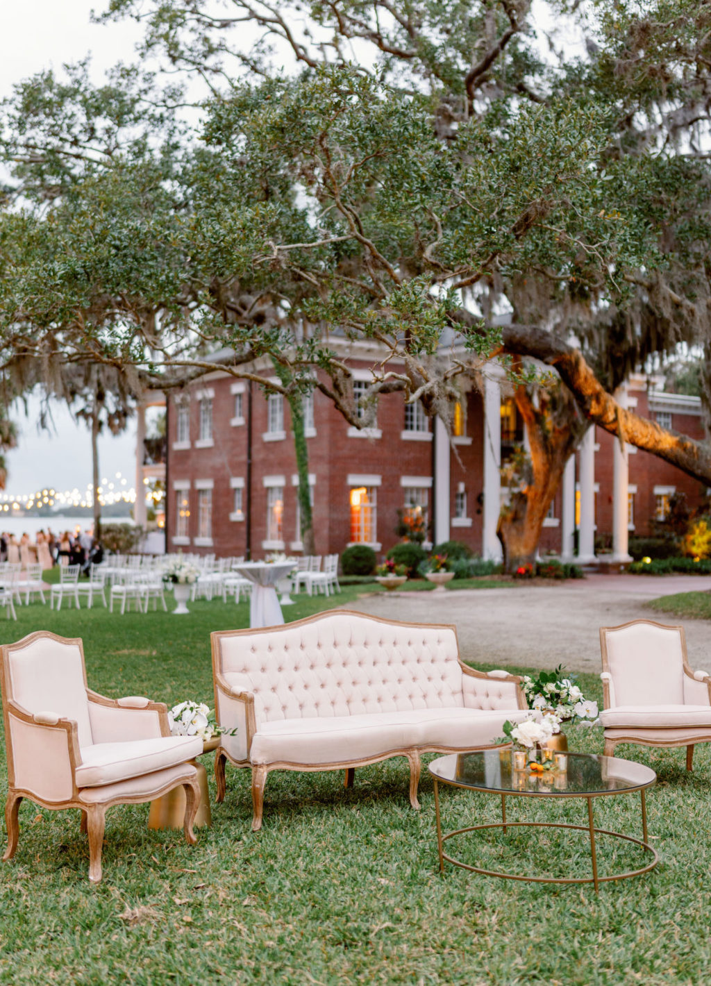 Luxurious Wedding Decor, Upholstered and Wooden Love Seat and Chairs, Gold Round Mirrored Cocktail Table Waterfront Lounge Seating | Tampa Bay NK Productions Wedding Planning | Wedding Venue Bay Preserve at Osprey