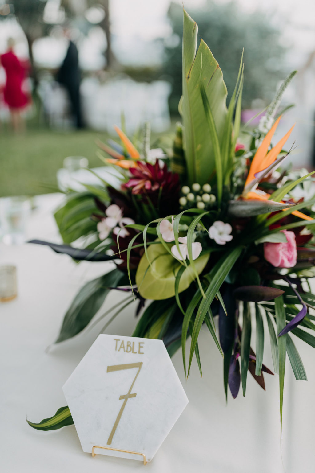 Tropical Elegant Wedding Reception Decor, Floral Centerpiece Orange Birds of Paradise, Pink Ginger, Palm Tree Leaves, White and Gold Geometric Table Number | Tampa Bay Wedding Photographer Amber McWhorter Photography