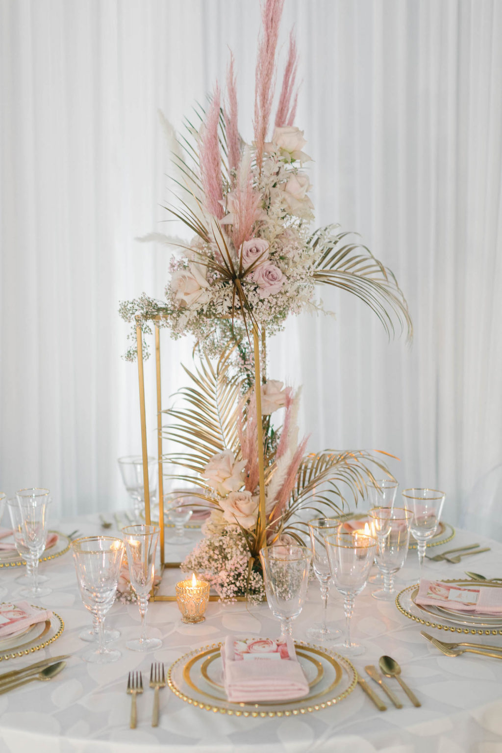 Clearwater Beach Wedding Venue Bellwether Beach Resort Styled With Love Something Bleu by McKenna Bleu | Instagram Wedding Designer Inspiration | Reception Table Linen with Gold Beaded Edge Charger and Gold Flatware with Blush Pink Napkin and Floral Menu Card | Gold Boho Centerpiece with Pampas Grass Roses and Palm Leaves