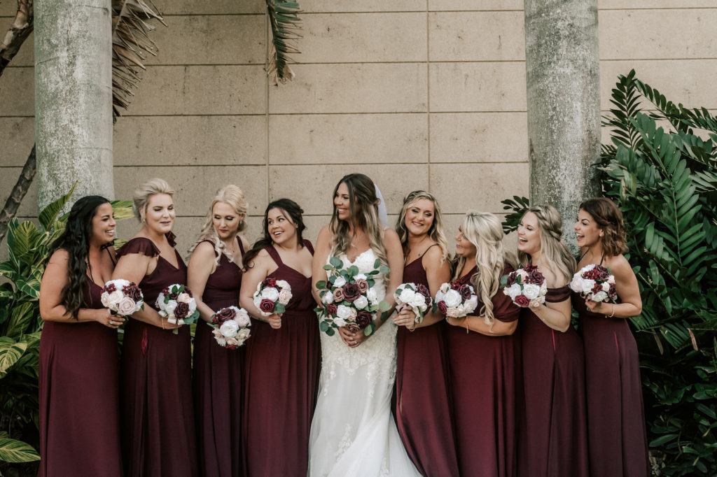 Florida Bride and Bridal Party, Bridesmaids in Long Burgundy Dresses Holding Soft Floral Bouquets with White, Pink, and Greenery Flowers