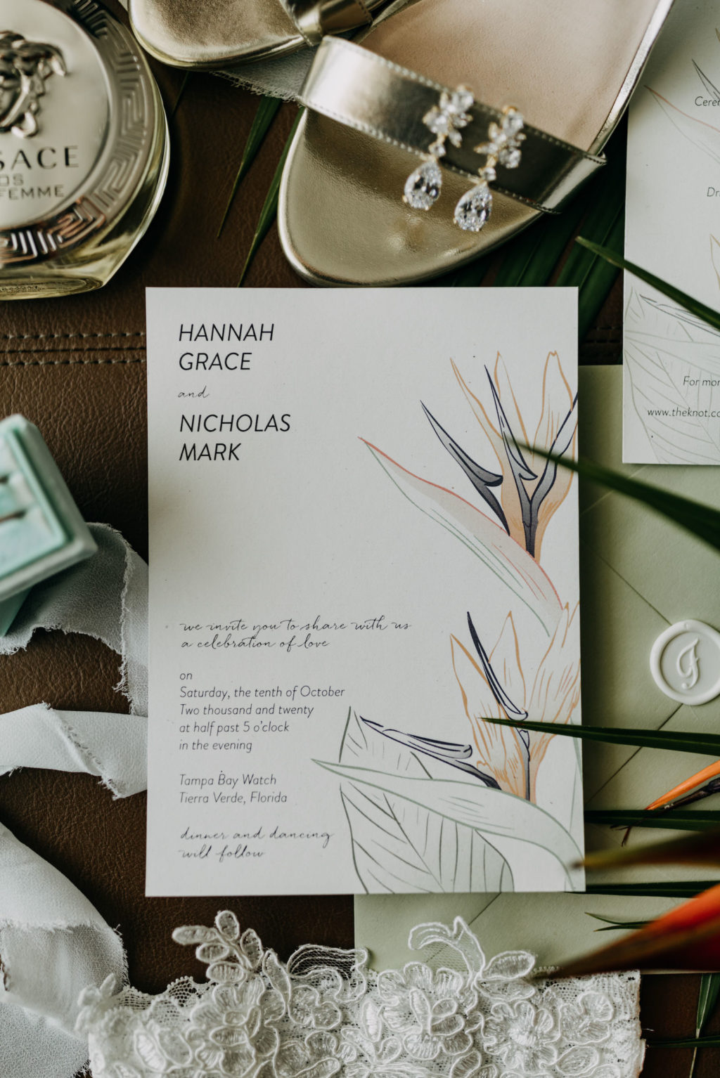 Tropical Elegant Wedding Invitation, Sage Green, White Invitation with Tropical Floral Design, Silver Strappy Wedding Shoes, Versace Perfume Bottle, Wedding Rings in Mint Green Box | Tampa Bay Wedding Photographer Amber McWhorter Photography