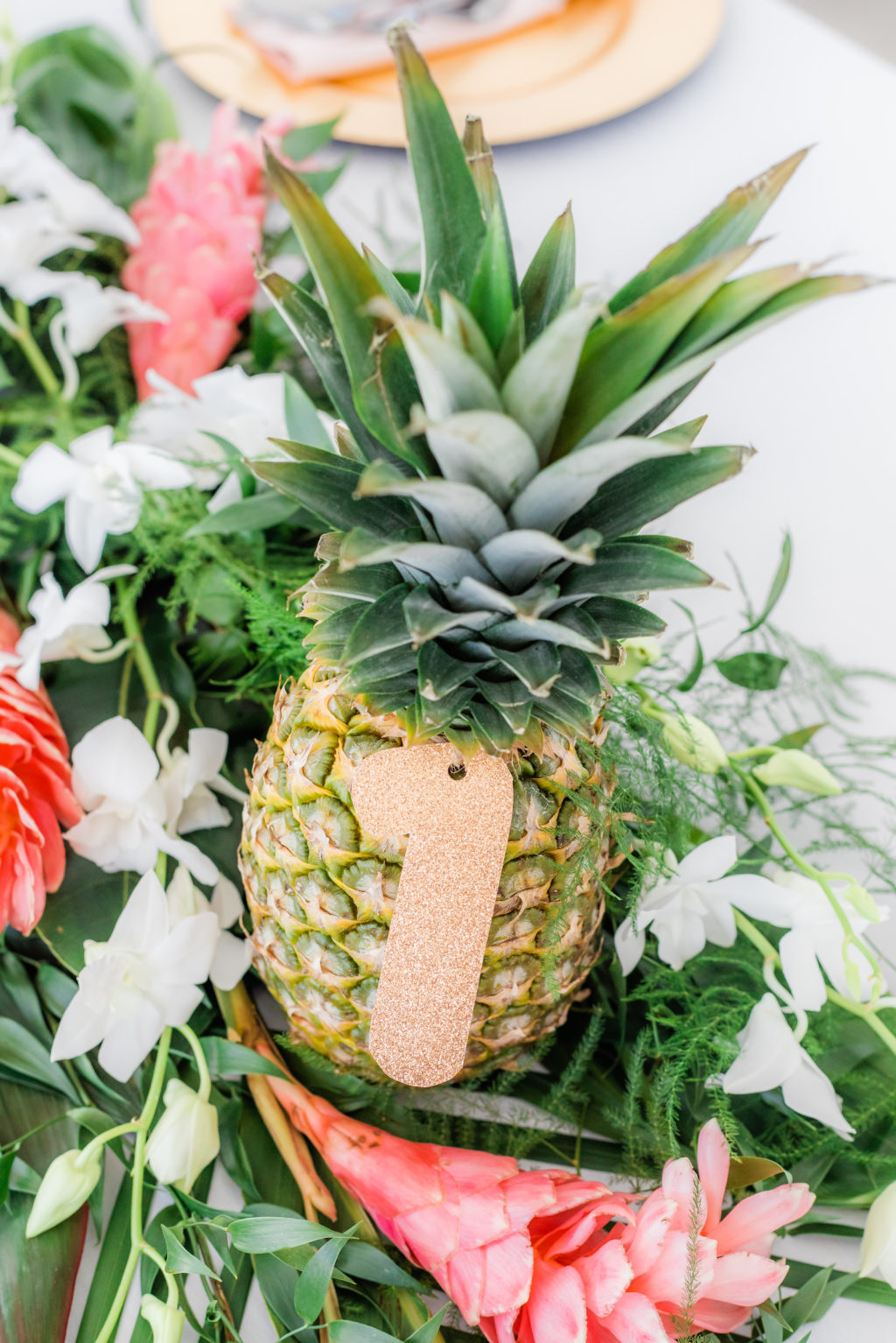 Elegant Tropical Wedding Reception Decor, Pineapple with Gold Table Number Cutout, Pink Ginger, Palm Fronds, White Orchids Floral Centerpiece | Tampa Bay Wedding Florist Iza's Flowers