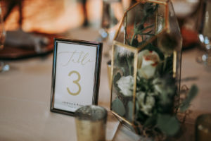 Framed Wedding Table Number Sign with Gold Geometric Terrarium Centerpiece Vase filled with Eucalyptus Greenery, White Roses and Blue Thistle